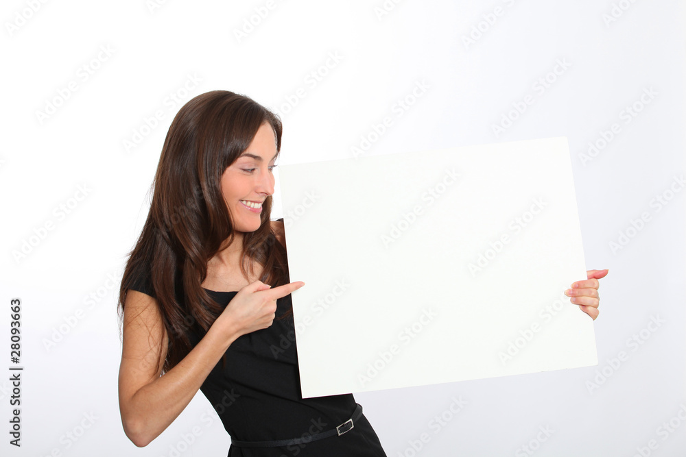 Woman in black dress showing message on white board Woman in black dress showing message on white board