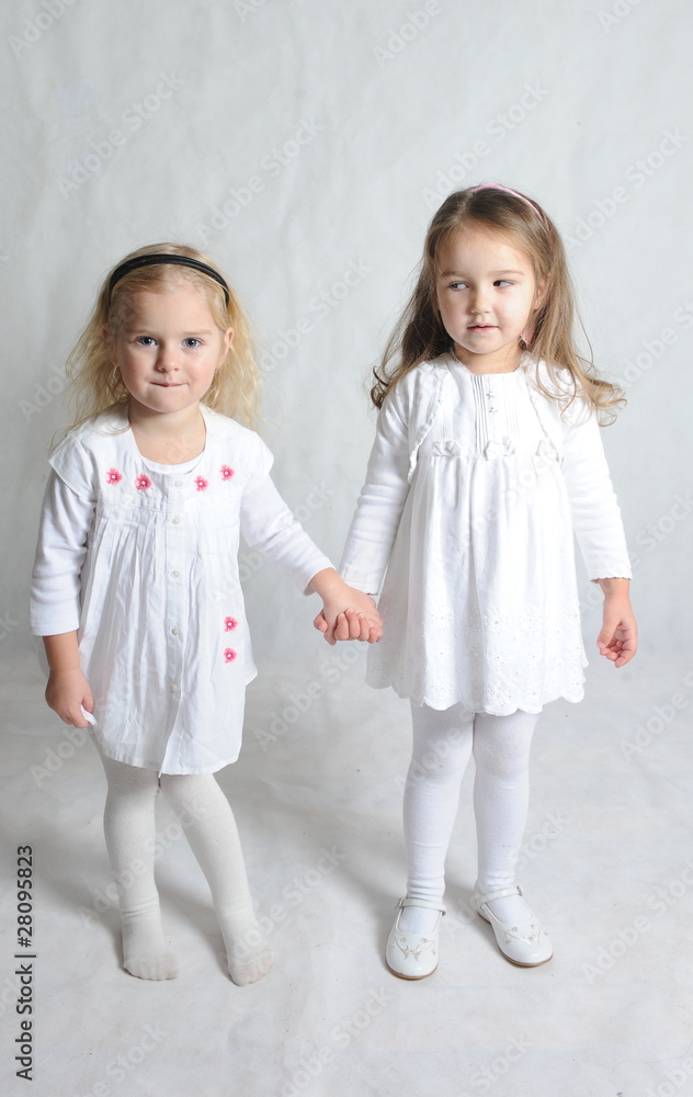 two little girls and one is looking jealously at other two little girls and one is looking jealously at other