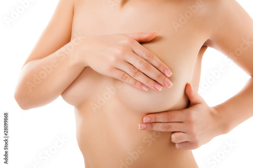 Fototapeta Woman examining her breast isolated on white