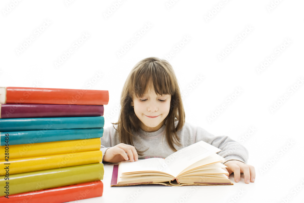 Young girl sitting at the desk and reading book. Young girl sitting at the desk and reading book.