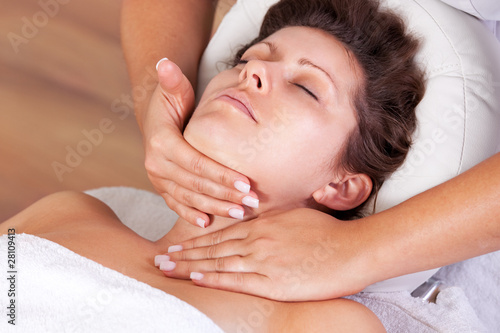 Young beautiful woman getting facial massage