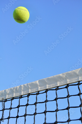 Yellow Tennis Ball Flying Over the Net © Mark Herreid