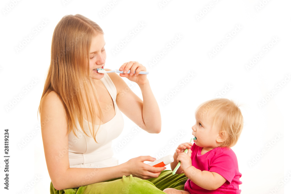 young woman and toddler girl brushing tooth young woman and toddler girl brushing tooth