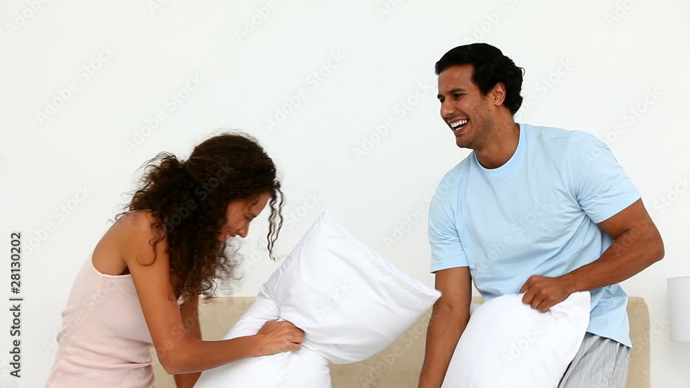 Man and woman doing a cushion figh Man and woman doing a cushion figh