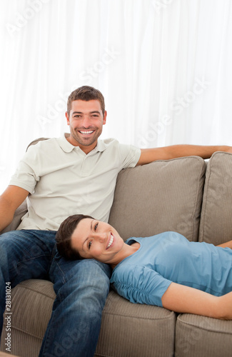 Portrait of a cheerful couple resting together on the sofa © WavebreakMediaMicro