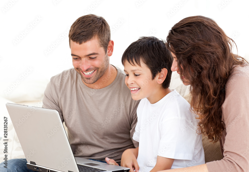 Cute family working on their laptop together sitting on the sofa Cute family working on their laptop together sitting on the sofa