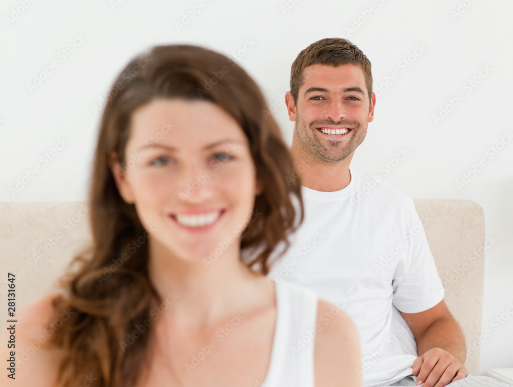 Happy man lying on his bed with his girlfriend Happy man lying on his bed with his girlfriend