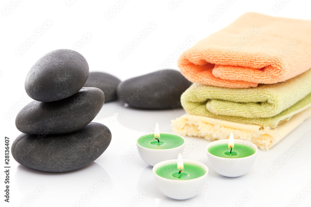 Obraz premium Therapeutic stones with towels and candles in spa