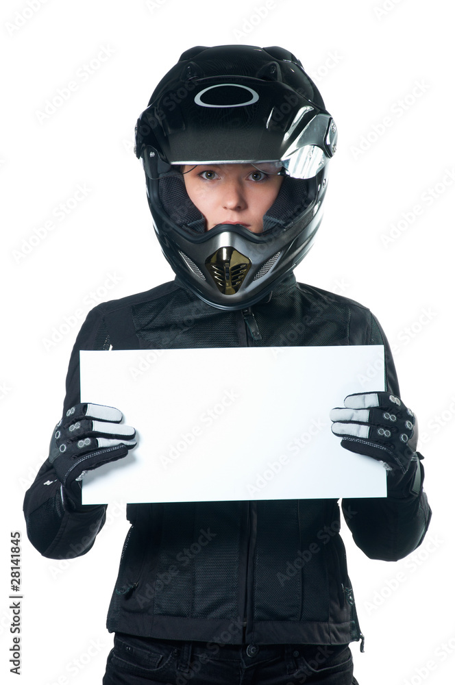 Woman in motorcycle clothing and helmet holding a white board Woman in motorcycle clothing and helmet holding a white board