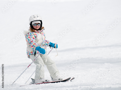 Little girl skiing downhill