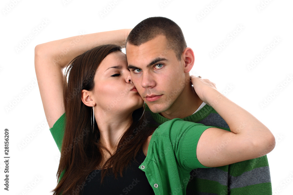 Naklejka premium Young girl kisses and hugs her boyfriend isolated on white