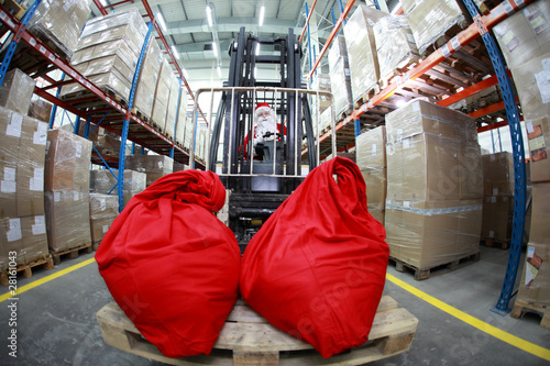 Santa Claus on forklift with two large red sacks - front