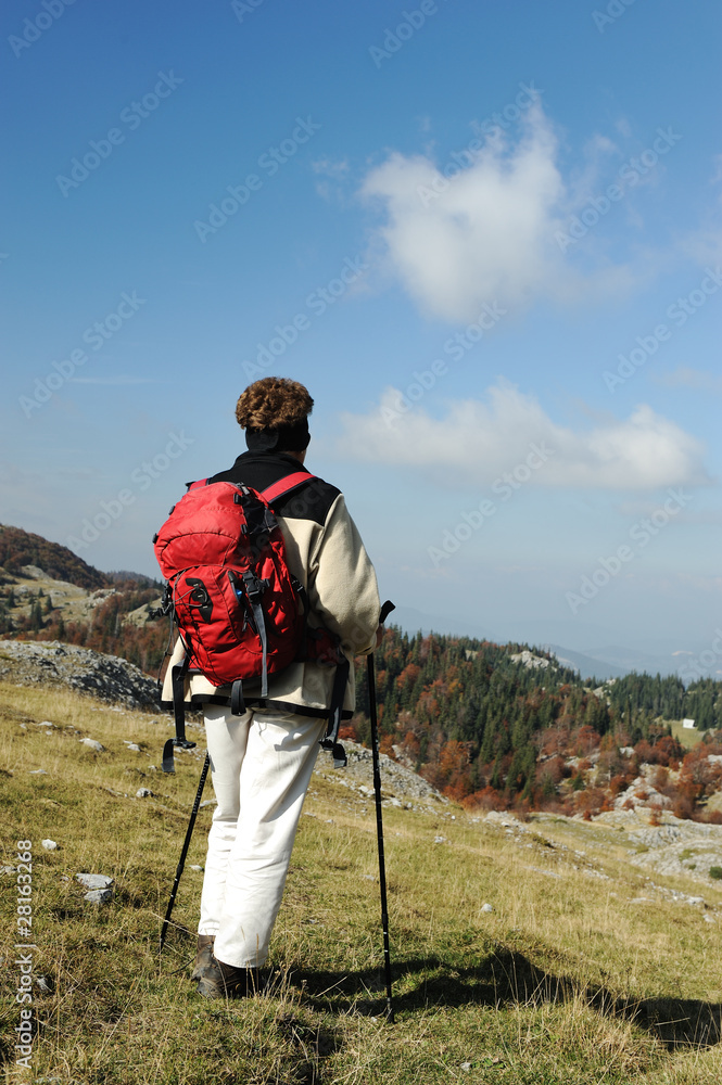 Female on the peak of mountain. Landscape composition.