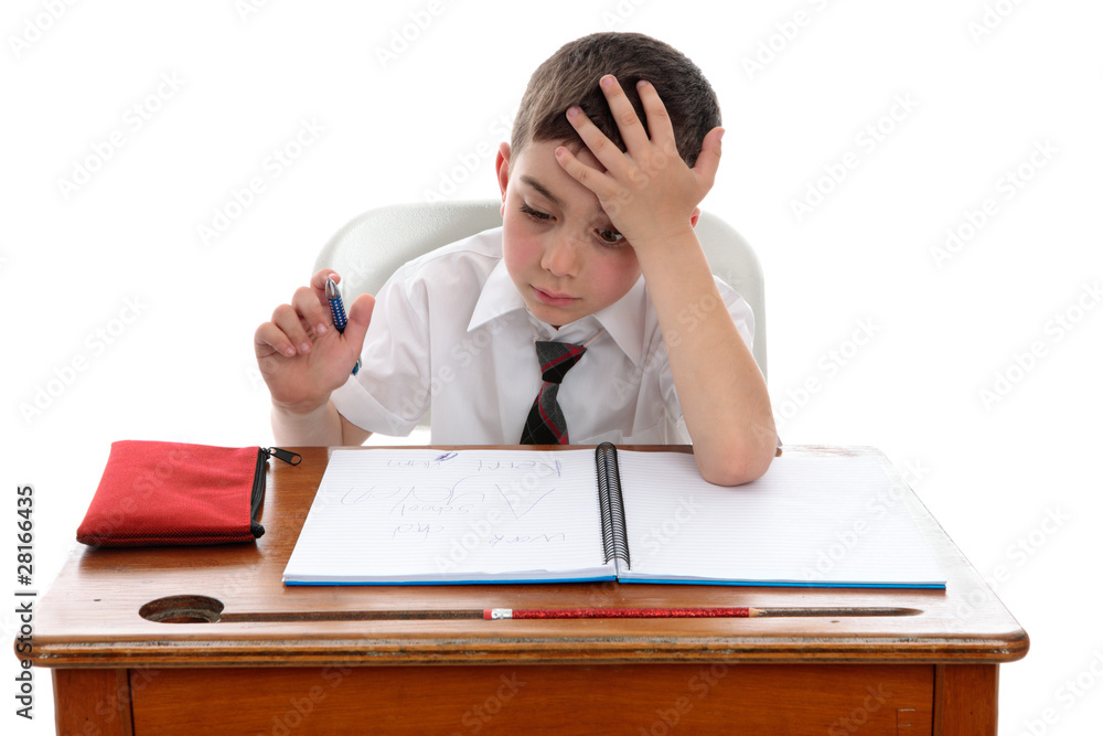 Boy thinkinhg at school desk