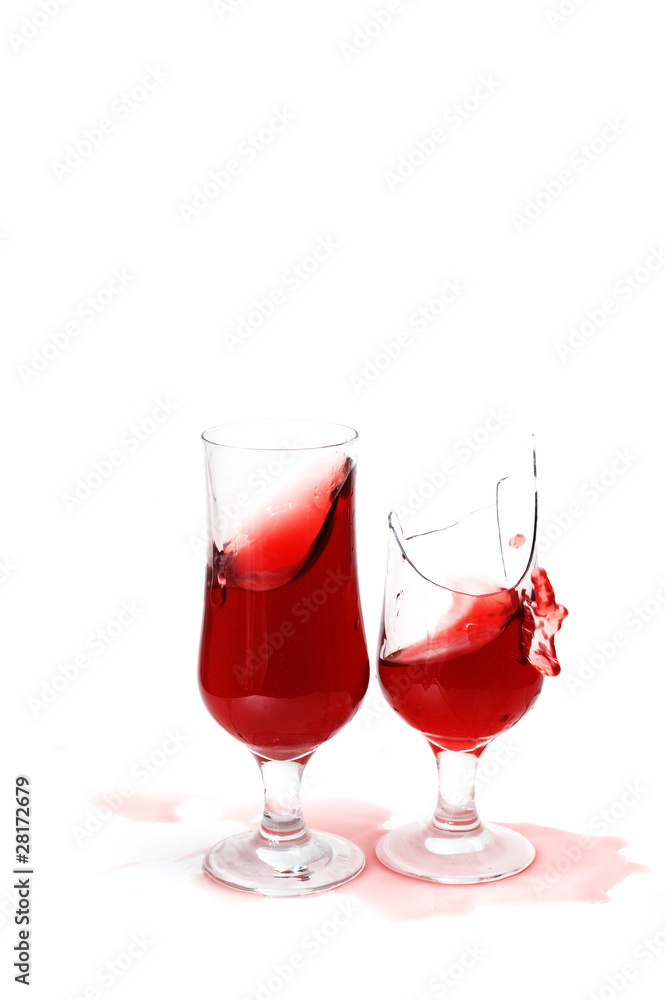 two glasses with wine and drops ,one glass is broken two glasses with wine and drops ,one glass is broken