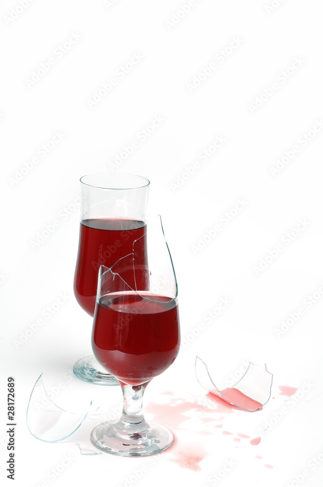 two glasses with wine and drops .one glass is broken two glasses with wine and drops .one glass is broken