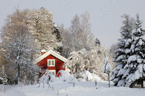 red cottage, snow and ice in sweden