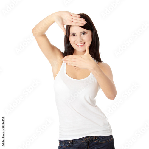 Young attractive woman framing her face