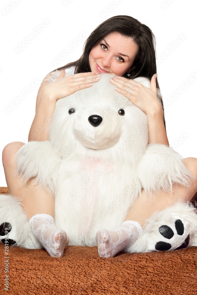 Beautiful girl sitting in an embrace with a teddy bear Beautiful girl sitting in an embrace with a teddy bear