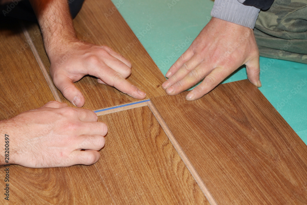 worker installing new laminate flooring worker installing new laminate flooring