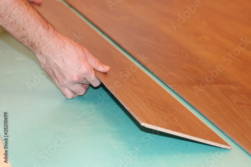 worker installing new laminate flooring