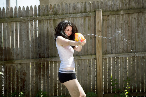 young female shooting a water gun
