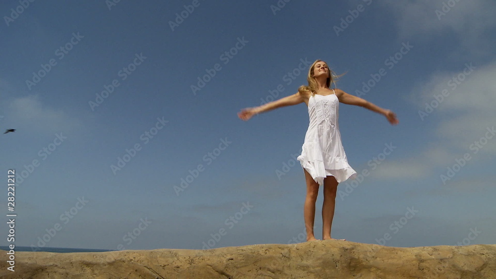 Young woman in white sundress enjoying summer beach Young woman in white sundress enjoying summer beach