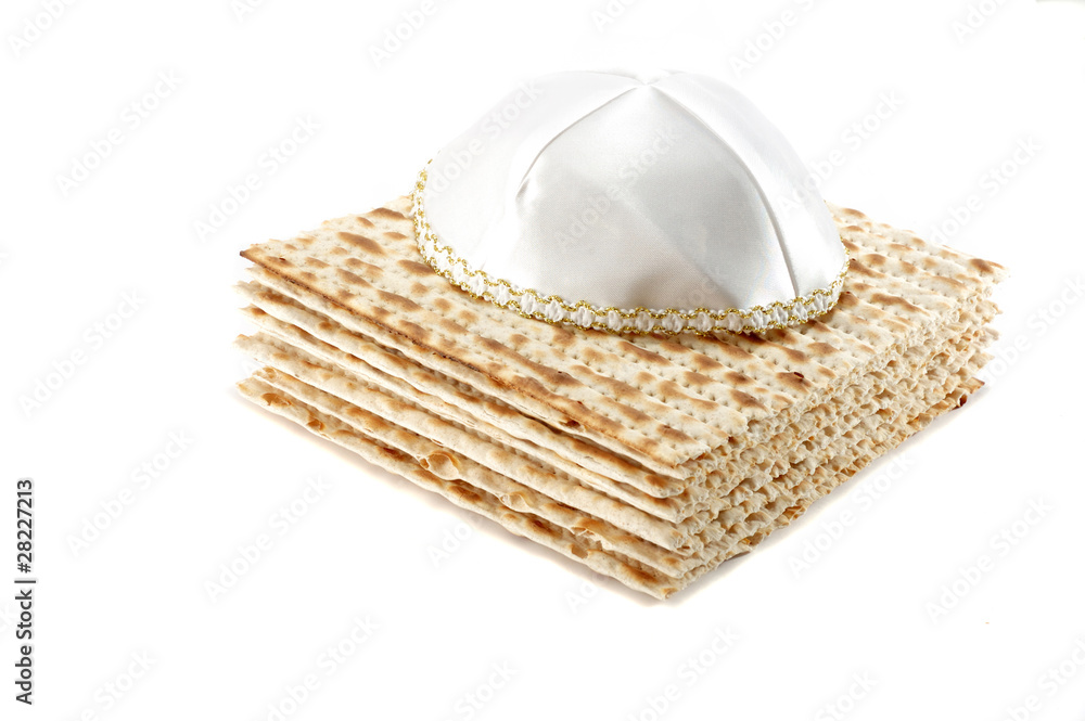Jewish Passover holiday still life with matzoh and kippah on whi