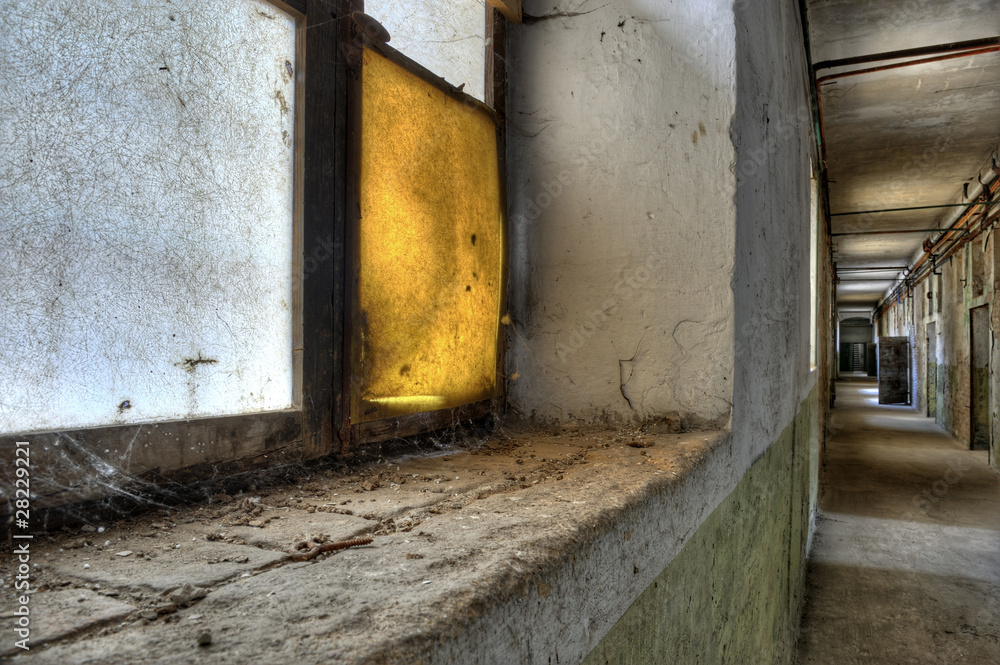 The dirty corridor of a disused prison.