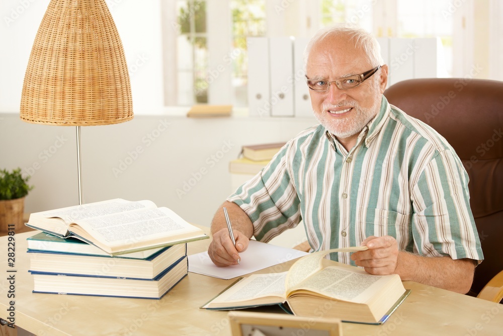 Elderly professor working in his study Elderly professor working in his study