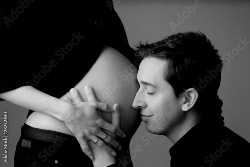 Father holding mother's belly