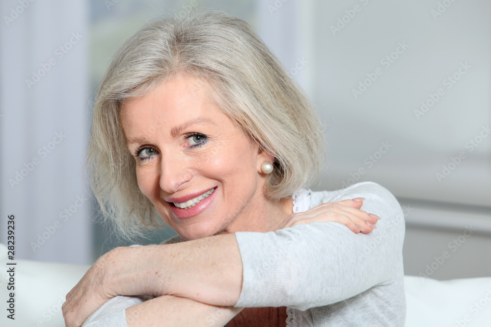Closeup of smiling senior woman relaxing at home Closeup of smiling senior woman relaxing at home