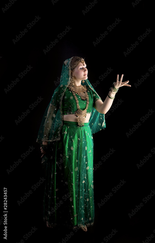 Fototapeta premium young girl in indian costume look at light