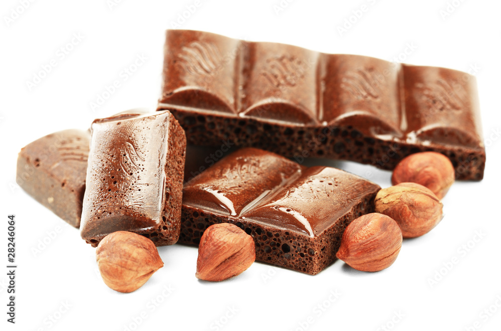 Dark chocolate and hazelnut on a white background Dark chocolate and hazelnut on a white background