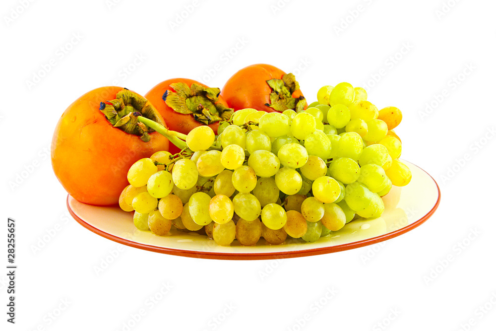 Grapes and persimmons on plate. Isolated on white Grapes and persimmons on plate. Isolated on white