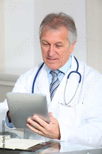 Closeup of doctor in the office with electronic pad