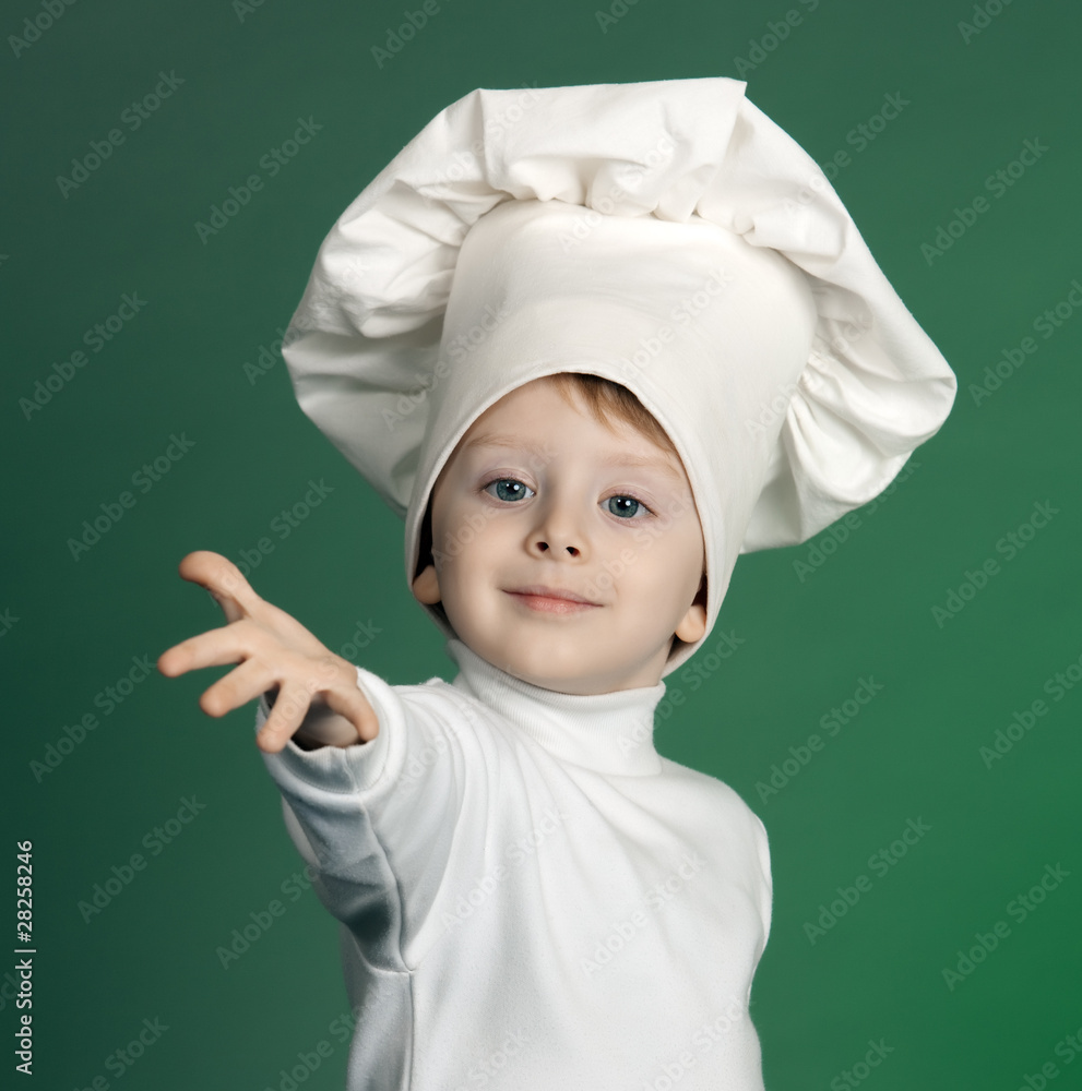 The cheerful little boy in a suit of the cook The cheerful little boy in a suit of the cook