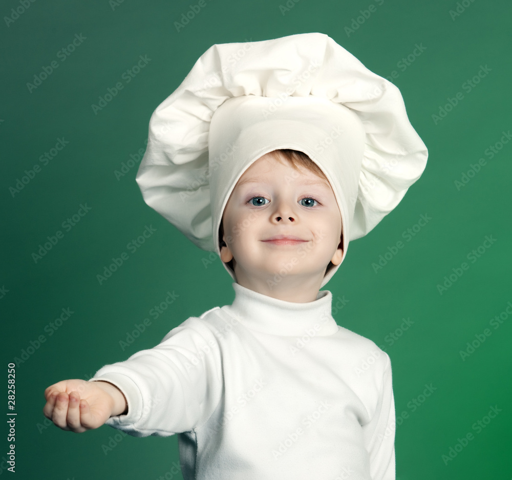 The cheerful little boy in a suit of the cook The cheerful little boy in a suit of the cook
