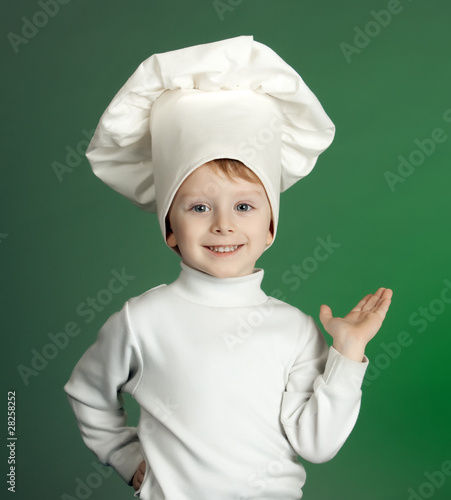 The cheerful little boy in a suit of the cook