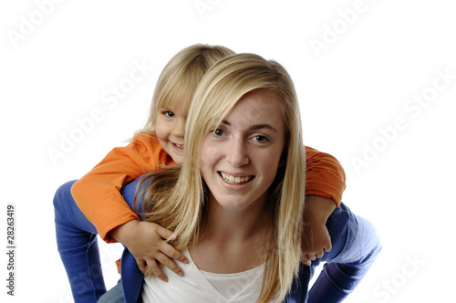Teenage girl piggybacks a toddler