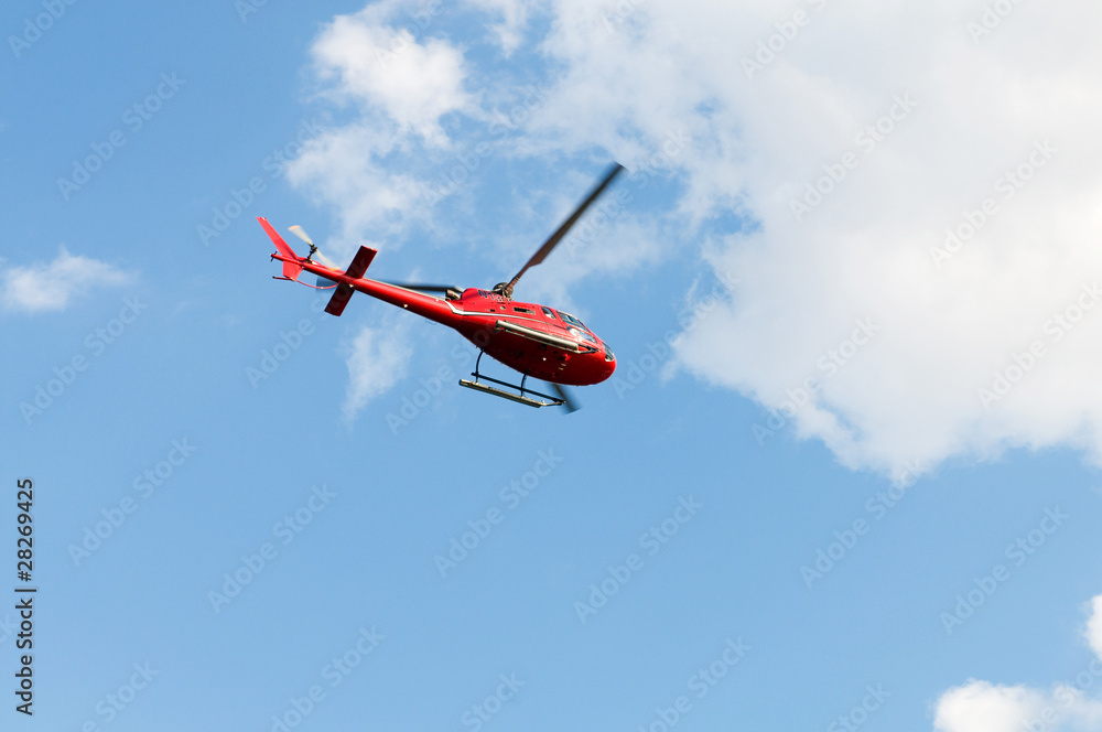 Red helicopter on the bright summer day Red helicopter on the bright summer day