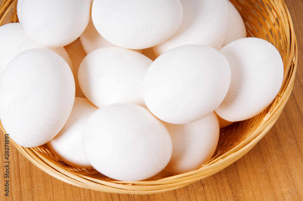 Many white eggs on the wooden table Many white eggs on the wooden table