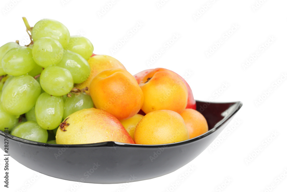 Grape, pear and apricot kept in bowl at shallow DOF