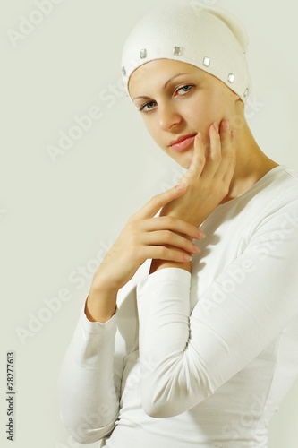 Attrective girl posing against grey wall