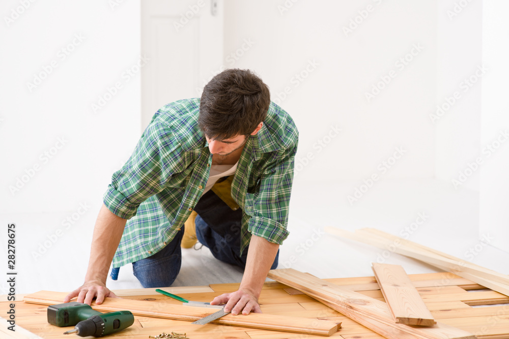 Home improvement - handyman installing wooden floor Home improvement - handyman installing wooden floor