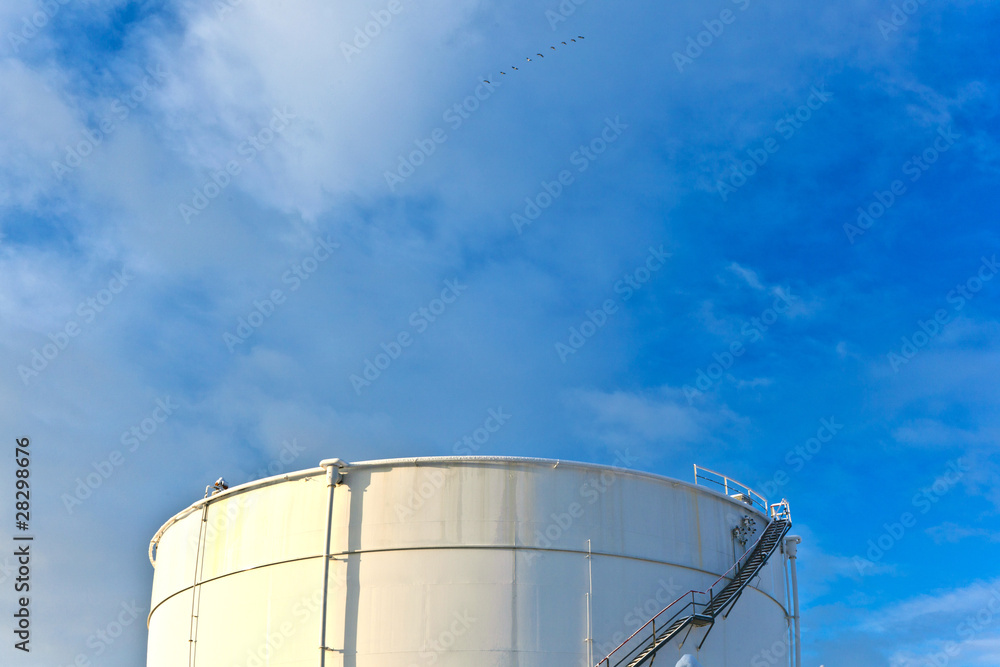 Fototapeta premium white tanks in tank farm with snow in winter