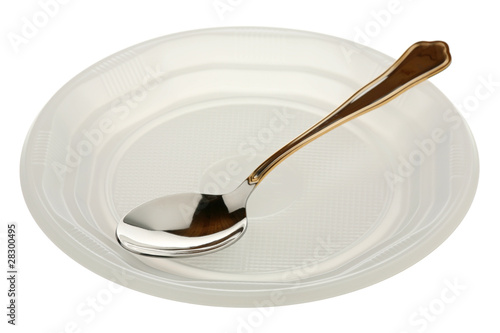 Metal spoon in a plastic plate photo