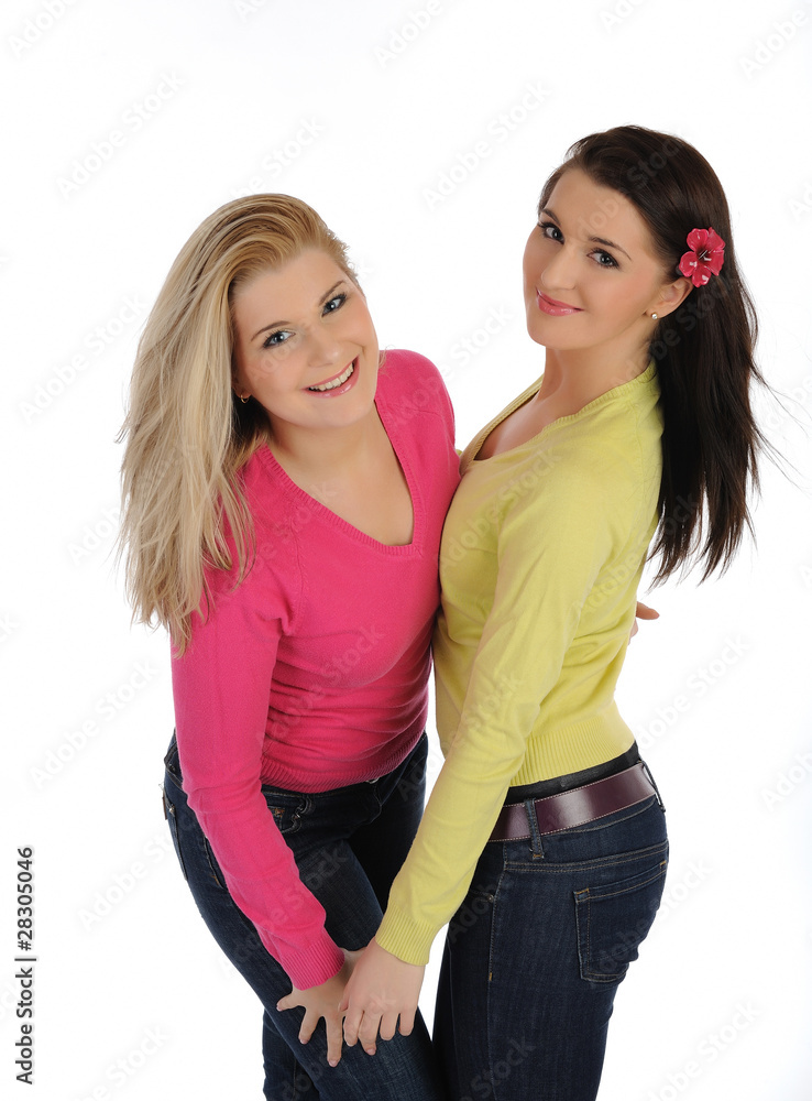 Two pretty girl friends having fun and laughing. isolated on whi Two pretty girl friends having fun and laughing. isolated on whi
