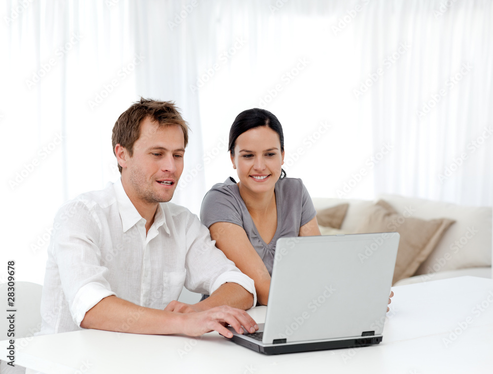 Happy man and woman looking at something on the laptop Happy man and woman looking at something on the laptop