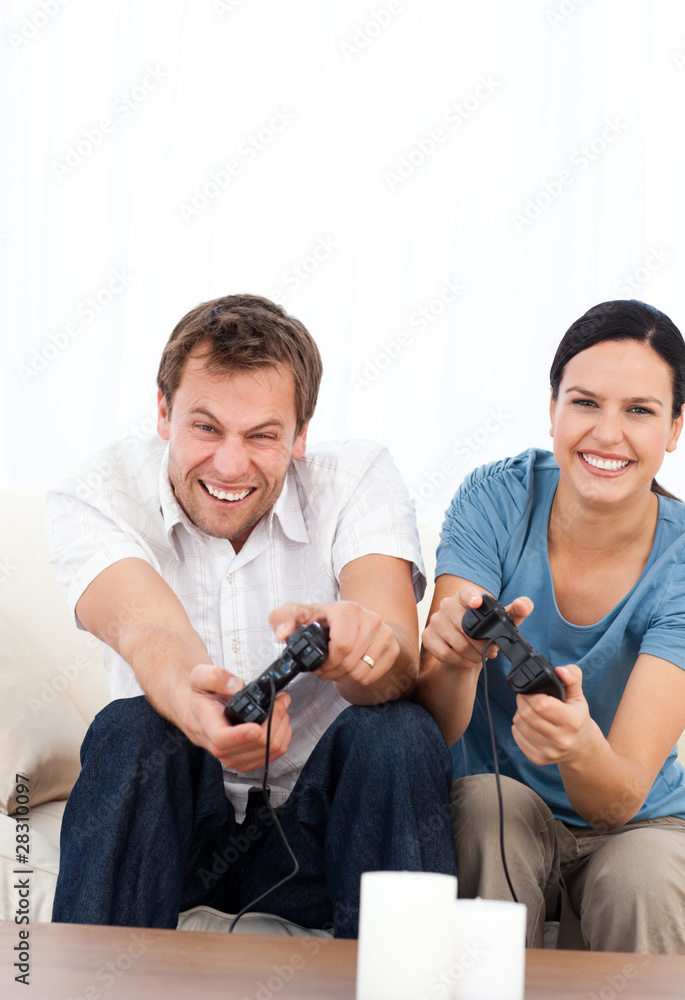 Excited man playing video games wth his girlfriend Excited man playing video games wth his girlfriend